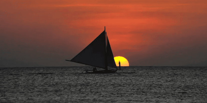 Klook: PHP 300 OFF on Boracay sunset paraw sailing experience and cruise along the coast aboard a traditional sailboat as the sun sets over the sea.